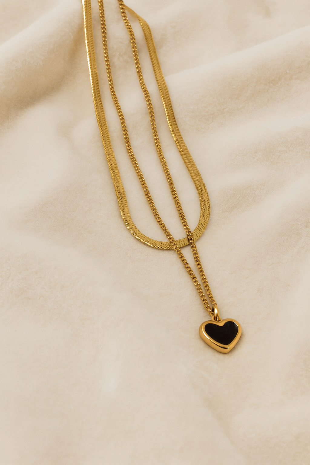 Elegant Golden Dual Chain Heart Pendant with Black Stone